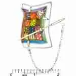 Patchwork quilt pin with needle and chain next to ruler showing approximately 1.75 in width