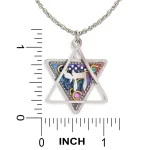 Necklace pendant next to ruler showing Star of David approximately 1.1 in high by 1 in wide