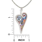 Necklace pendant next to ruler showing heart approximately 1.45 in high by 0.75 in wide