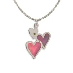 Back of double heart pendant showing stainless steel frames, painted reverse in pink, and brass rivet