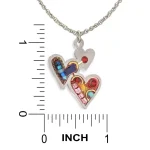 Necklace pendant next to ruler showing double heart approximately 1 in high by 0.75 in wide